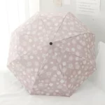 Parapluie pliant fleuri rose, motif floral élégant, ouvert en vue de dessus, parfait pour un style chic et pratique.
