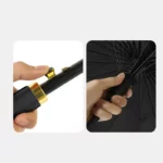 Gros plan sur la poignée dorée d’un parapluie pliant semi-automatique noir, robuste et élégant, idéal pour toutes les occasions.
