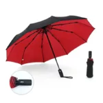 Parapluie tempête automatique rouge et noir, design élégant, protection efficace contre la pluie, avec housse pratique.
