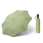 Parapluie anti-UV original vert pastel, design unique et compact, idéal pour se protéger du soleil avec style et praticité.