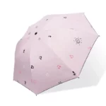 Parapluie rose élégant avec motifs musicaux et flocons de neige, parfait pour allier style et protection sous la pluie.
