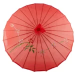Parapluie japonais rouge traditionnel avec motifs floraux raffinés, design élégant, idéal pour apporter une touche d'art et de culture.