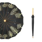 Parapluie japonais élégant noir avec motifs dorés, longue poignée en bois, alliant style raffiné et protection contre la pluie.