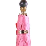 Parapluie luxe rose avec manche doré et pommeau cristal, accessoire élégant et pratique, parfait pour toutes les saisons.