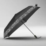 Parapluie pliant coloré issu de la collection [Collection], design élégant avec motif paisley blanc, déployé sur fond neutre.