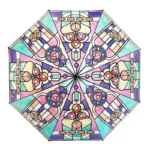 Parapluie transparent ouvert avec motif vitrail coloré, formes géométriques et florales pastel, style élégant et artistique.
