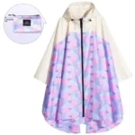 Poncho femme coloré avec motifs géométriques roses et bleus, capuche, fermeture éclair et étui de rangement pratique.