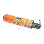 Parapluie automatique coloré au design colibri sur fond orange, compact et élégant, parfait pour se protéger de la pluie.