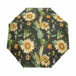Parapluie de poche automatique motif floral tournesols colorés sur fond noir, chic et pratique pour affronter la pluie élégamment.