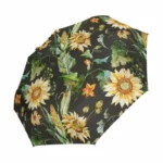 Parapluie automatique de poche avec motifs floraux tournesols, éléments botaniques sur fond noir, idéal pour un style élégant.