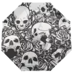 Parapluie automatique solide avec motifs crânes et roses noir/blanc, design artistique élégant, protection stylée contre la pluie.