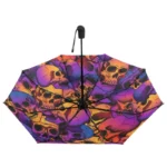 Parapluie automatique solide avec motifs de têtes de mort colorées, violet, orange et jaune, parfait pour un style unique par tous temps.