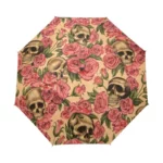 Parapluie automatique tête de mort avec motifs crânes et roses, accessoire stylé et pratique pour une protection contre la pluie.