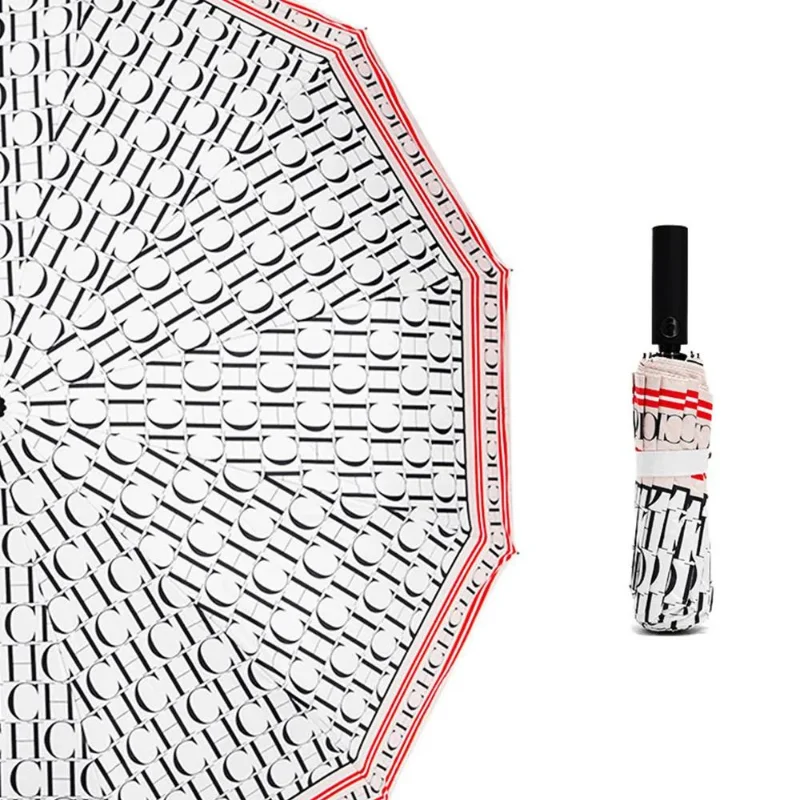 Parapluie de luxe imperméable, design élégant avec motifs noir et blanc, accents rouges, plié et déployé pour présentation.