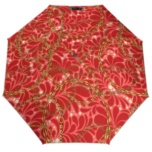 Parapluie femme glamour avec motif chaînes dorées sur fond rouge, accessoire chic et tendance pour une protection élégante.