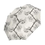 Parapluie femme résistant, motif floral noir et blanc sur fond crémeux, élégant et pratique pour allier style et protection contre la pluie.