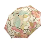 Parapluie femme romantique avec motifs floraux et oiseaux colorés, style élégant et délicat pour une protection chic contre la pluie.