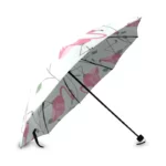 Parapluie compact à motifs flamants roses sur fond blanc, élégant et pratique, parfait pour associer style et protection contre la pluie.
