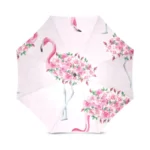 Parapluie rose élégant avec motifs de flamants roses et fleurs, idéal pour un style unique et coloré par temps de pluie.