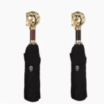 Parapluies homme élégants pliés, poignées tête de lion, manches bois et noir, housses noires raffinées pour un style sophistiqué.