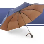 Parapluie homme robuste bleu à motifs, doublure marron élégante, idéal contre la pluie, sur fond graphique moderne.