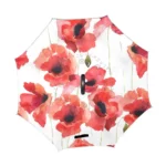 Parapluie inversé femme avec motifs floraux aquarelle, coquelicots rouges sur fond blanc, alliant style et protection contre la pluie.