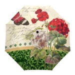 Parapluie motifs floraux colorés avec géraniums rouges et blancs, papillon, design élégant nature, teintes vertes et graphiques.