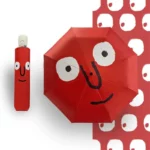 Parapluie original rouge avec visage souriant, design coloré, étui assorti, parfait pour égayer les jours de pluie.