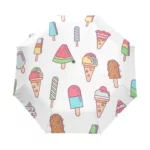 Parapluie pliable original avec motifs colorés de glaces et bonbons sur fond blanc, parfait pour un style fun et unique.