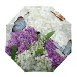 Parapluie avec motifs papillons et fleurs colorées, lilas et muguets, design élégant et vibrant parfait pour illuminer vos sorties.