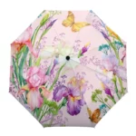 Parapluie élégant avec motifs papillons et fleurs colorées sur fond rose, idéal pour rester stylé sous la pluie.
