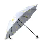 Parapluie pliant de voyage avec motifs marguerites blanches et jaunes, design élégant et pratique pour se protéger de la pluie.