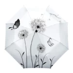 Parapluie pliant décoré de motifs pissenlits sur fond blanc, pratique et stylé pour affronter les journées pluvieuses.