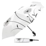 Parapluie pliant élégant à motif pissenlit noir sur fond blanc avec étui assorti, pratique et stylé pour vous protéger de la pluie.