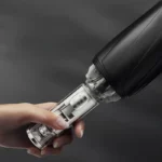 Parapluie tempête robuste noir, élégant et durable, avec mécanisme innovant, idéal contre les intempéries, sur fond sombre.