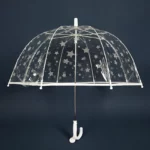 Parapluie transparent léger avec motif étoiles blanches, structure métal blanc, design élégant pour une protection sous la pluie.
