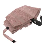 Petit parapluie féminin élégant rose et noir, compact et raffiné, parfait pour protéger avec style durant les journées pluvieuses.