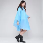 Poncho pluie bleu clair avec capuche, élégant et pratique, parfait pour les jours pluvieux. Collection tendance et confortable.