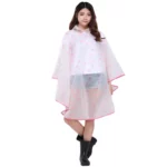 Poncho pluie transparent motifs lèvres roses, style tendance et coloré, parfait avec des bottes noires pour affronter la pluie.