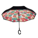 Parapluie inversé chic avec motif de feuilles rouge, vert et beige, design élégant, parfait pour un style unique sous la pluie.
