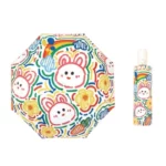 Parapluie enfant automatique coloré avec motifs amusants de lapins, fleurs et arc-en-ciel, idéal pour égayer les journées pluvieuses.