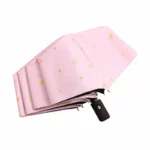 Parapluie enfant pliant automatique rose avec motifs couronnes et étoiles dorées, pratique et élégant pour toutes saisons.