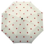 Parapluie automatique beige orangé à pois rouges, design unique avec ondulations élégantes, idéal pour la pluie et les intempéries.