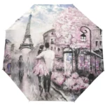 Parapluie pliant manuel décoré avec la Tour Eiffel et une scène romantique de Paris, idéal pour toutes les saisons.