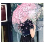 Parapluie transparent fleuri avec motifs roses, accessoire tendance pour se protéger de la pluie avec style et légèreté.