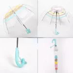 Parapluie cloche transparent pour enfants avec motifs colorés et poignée turquoise, idéal pour protection ludique sous la pluie.