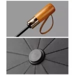 Parapluie inversé automatique avec manche en bois, bouton doré et tissu noir premium, élégant et pratique, idéal par tous temps.