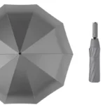 Parapluie tempête grand format gris ouvert avec design moderne et pratique, parfait pour affronter la pluie avec style.