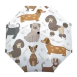 Parapluie manuel décoré de motifs de chiens adorables, empreintes de pattes et os sur fond blanc, design original et pratique.