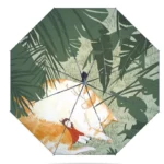 Parapluie noir manuel avec dessins chat orange, feuillage tropical et petite fille rouge, allié de style et protection par tous temps.